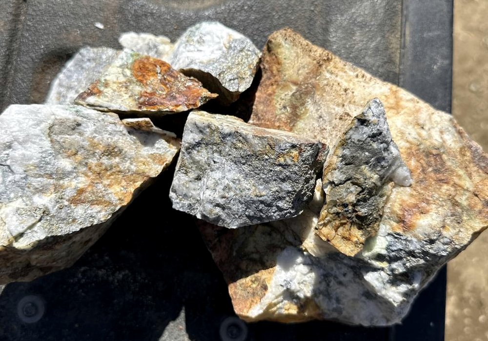 Hand specimens of mineralized quartz with sulfide staining